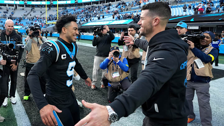 Panthers head coach Dave Canales celebrates with quarterback Bryce Young after their big win over the Buccaneers on Sunday.