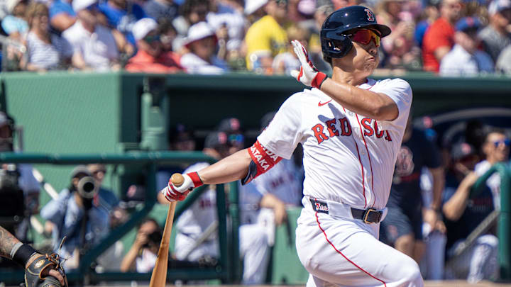 Mar 2, 2025; Fort Myers, Florida, USA;  Boston Red Sox Masataka Yoshida (7) hits a ground-rule double on a line drive to right field in the first inning of their game with the New York Mets at JetBlue Park at Fenway South. Mandatory Credit: Chris Tilley-Imagn Images