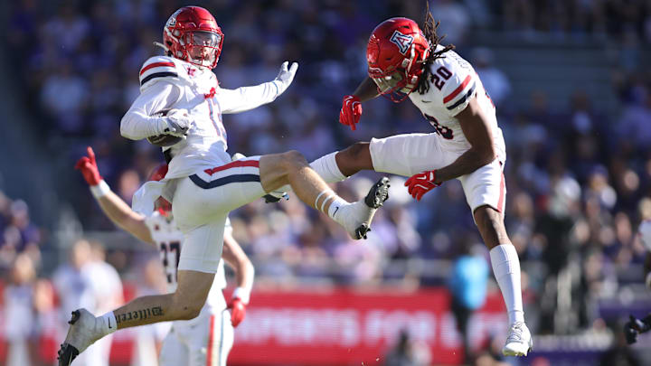 Nov 23, 2024; Fort Worth, Texas, USA; Arizona Wildcats defensive back Jack Luttrell (13) and defensive back Marquis Groves-Killebrew (20) celebrate an interception in the first quarter against the TCU Horned Frogs  at Amon G. Carter Stadium. Mandatory Credit: Tim Heitman-Imagn Images