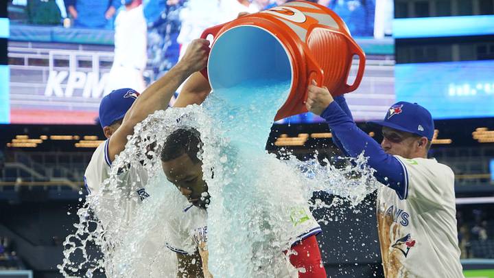 Toronto Blue Jays designated hitter Anthony Santander (right) and center fielder Myles Straw (left) douse first baseman Vladimir Guerrero (27) with ice water after a win over the Atlanta Braves at Rogers Centre. Toronto Blue Jays designated hitter Anthony Santander (right) and center fielder Myles Straw (left) douse first baseman Vladimir Guerrero (27) with ice water after a win over the Atlanta Braves at Rogers Centre.