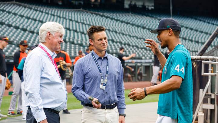 Jun 27, 2022; Seattle, Washington, USA; Seattle Mariners center fielder Julio Rodriguez (44) talks with majority owner John Stanton, left, and general manager Jerry Dipoto during batting practice against the Baltimore Orioles at T-Mobile Park. Mandatory Credit: Joe Nicholson-USA TODAY Sports Jun 27, 2022; Seattle, Washington, USA; Seattle Mariners center fielder Julio Rodriguez (44) talks with majority owner John Stanton, left, and general manager Jerry Dipoto during batting practice against the Baltimore Orioles at T-Mobile Park. Mandatory Credit: Joe Nicholson-USA TODAY Sports