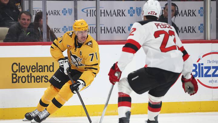 Pittsburgh Penguins center Evgeni Malkin (71) skates with the puck against New Jersey Devils defenseman Brett Pesce (22) during the first period at PPG Paints Arena. Mandatory Credit: Charles LeClaire-Imagn Images