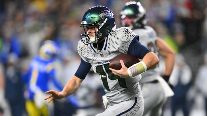 Dec 18, 2025; Seattle, Washington, USA; Seattle Seahawks quarterback Sam Darnold (14) runs against the Los Angeles Rams in the first half at Lumen Field. Mandatory Credit: Steven Bisig-Imagn Images