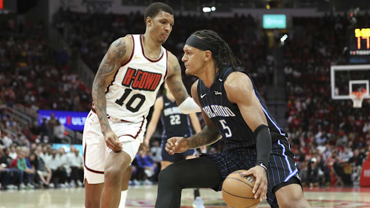 Mar 10, 2025; Houston, Texas, USA; Orlando Magic forward Paolo Banchero (5) drives with the ball as Houston Rockets forward Jabari Smith Jr. (10) defends during the third quarter at Toyota Center. Mandatory Credit: Troy Taormina-Imagn Images