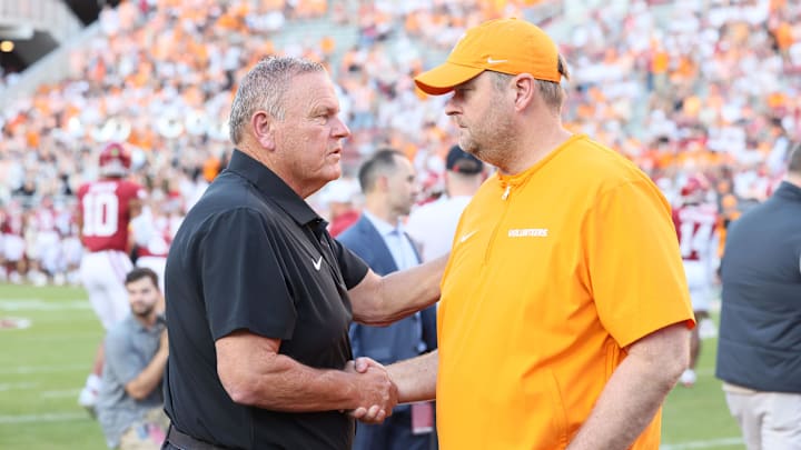 Oct 5, 2024; Fayetteville, Arkansas, USA; Arkansas Razorbacks head coach Sam Pittman talks to Tennessee Volunteers head coach Josh Heupel prior to the game at Donald W. Reynolds Razorback Stadium. Mandatory Credit: Nelson Chenault-Imagn Images