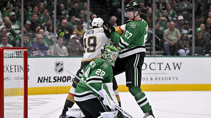 Mar 10, 2026; Dallas, Texas, USA; Dallas Stars defenseman Tyler Myers (57) moves Vegas Golden Knights right wing Reilly Smith (19) out of the crease in front of goaltender Jake Oettinger (29) during the third period at the American Airlines Center. Mandatory Credit: Jerome Miron-Imagn Images
