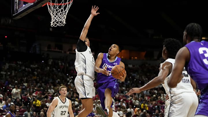 Jul 14, 2025; Las Vegas, NV, USA;  Utah Jazz forward John Tonje (17) drives towards the basket against San Antonio Spurs forward Carter Bryant (11) during the first half of a NBA basketball game at the Thomas & Mack Center. Mandatory Credit: Lucas Peltier-Imagn Images