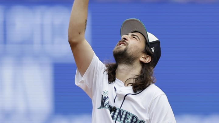 Grammy nominated musician Noah Kahan points to the sky after throwing out the ceremonial first pitch at T-Mobile Park on June 30.