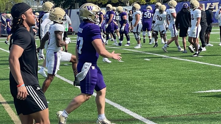 Cameron Warchuck is shown in warm-ups at his last UW football practice, just ahead of injured receiver Omari Evans.