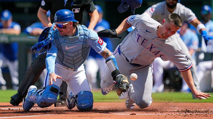 Texas Rangers shortstop Corey Seager collides with Kansas City Royals catcher Carter Jensen at home plate. Texas Rangers shortstop Corey Seager collides with Kansas City Royals catcher Carter Jensen at home plate.