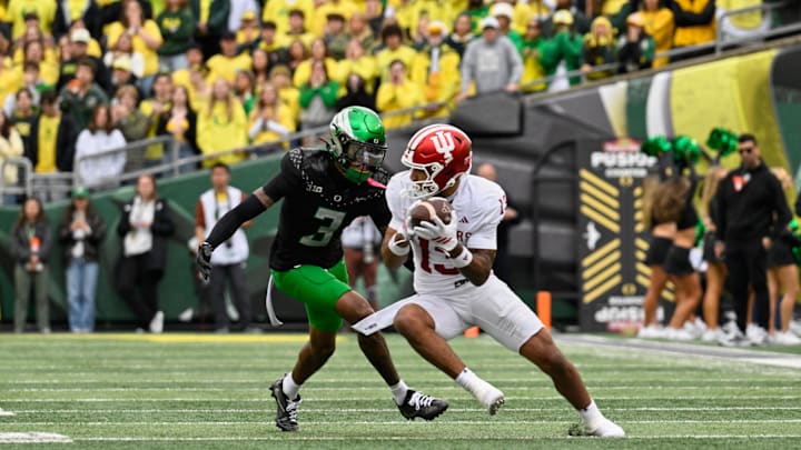 Oct 11, 2025; Eugene, Oregon, USA; Indiana Hoosiers wide receiver Elijah Sarratt (13) runs with the ball against Oregon Ducks defensive back Sione Laulea (3) during the second quarter at Autzen Stadium. Mandatory Credit: Troy Wayrynen-Imagn Images