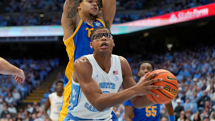Feb 8, 2025; Chapel Hill, North Carolina, USA; North Carolina Tar Heels forward James Brown (2) with the ball as Pittsburgh Panthers forward Cameron Corhen (2) defends in the second half at Dean E. Smith Center. Mandatory Credit: Bob Donnan-Imagn Images