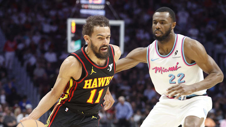 Mar 27, 2025; Miami, Florida, USA;  Miami Heat forward Andrew Wiggins (22) defends Atlanta Hawks guard Trae Young (11) during the second half at Kaseya Center. Mandatory Credit: Rhona Wise-Imagn Images