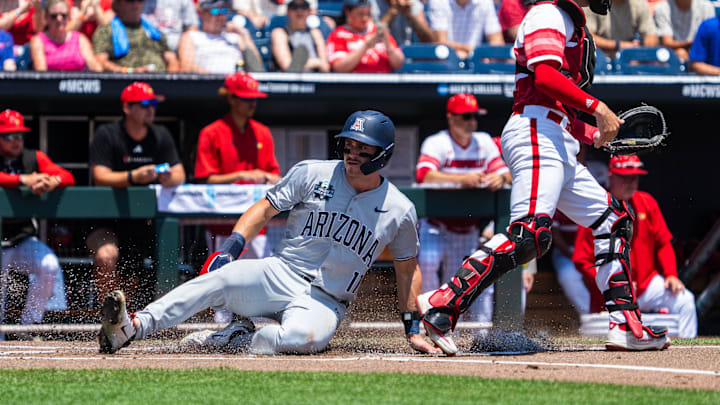 Jun 15, 2025; Omaha, Neb, USA; Arizona Wildcats center fielder Aaron Walton (11) scores against the Louisville Cardinals during the first inning at Charles Schwab Field. Mandatory Credit: Dylan Widger-Imagn Images