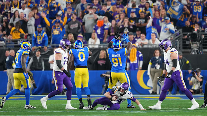 Jan 13, 2025; Glendale, AZ, USA; Los Angeles Rams defensive tackle Kobie Turner (91) reacts after making a sack on Minnesota Vikings quarterback Sam Darnold (14) during the first half in an NFC wild card game at State Farm Stadium. Mandatory Credit: Joe Camporeale-Imagn Images Jan 13, 2025; Glendale, AZ, USA; Los Angeles Rams defensive tackle Kobie Turner (91) reacts after making a sack on Minnesota Vikings quarterback Sam Darnold (14) during the first half in an NFC wild card game at State Farm Stadium. Mandatory Credit: Joe Camporeale-Imagn Images