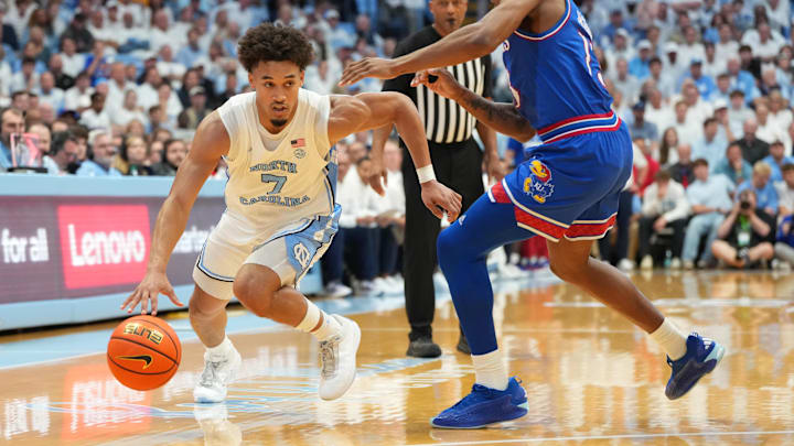 Nov 7, 2025; Chapel Hill, North Carolina, USA;  North Carolina Tar Heels guard Seth Trimble (7) with the ball as Kansas Jayhawks guard Elmarko Jackson (13) defends in the second half at Dean E. Smith Center. Mandatory Credit: Bob Donnan-Imagn Images