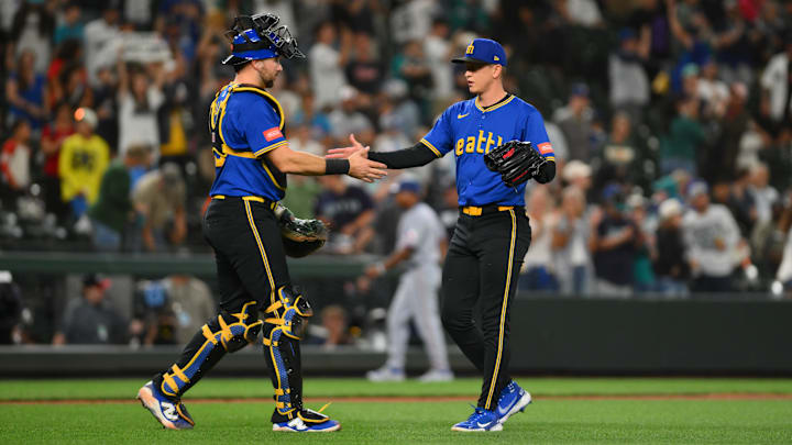 Jul 31, 2025; Seattle, Washington, USA; Seattle Mariners catcher Cal Raleigh (29) and relief pitcher Casey Legumina (64) celebrate after defeating the Texas Rangers at T-Mobile Park. Mandatory Credit: Steven Bisig-Imagn Images