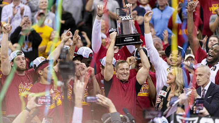 Mar 16, 2024; Kansas City, MO, USA; Streamers fall as Iowa State Cyclones head coach TJ Otzelberger hoists the Big 12 Tournament trophy alongside his team after defeating the Houston Cougars at T-Mobile Center. Mandatory Credit: Amy Kontras-Imagn Images