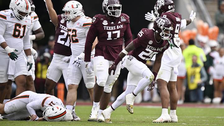 Texas A&M Aggies safety Dalton Brooks (25) and Texas A&M Aggies linebacker Taurean York (21) celebrated after sacking Miami Hurricanes quarterback Carson Beck (11) during first half of the first round game of the CFP National Playoff at Kyle Field. 