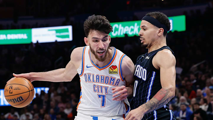 Jan 13, 2024; Oklahoma City, Oklahoma, USA; Oklahoma City Thunder forward Chet Holmgren (7) drives to the basket against Orlando Magic guard Cole Anthony (50) during the second half at Paycom Center. Mandatory Credit: Alonzo Adams-Imagn Images