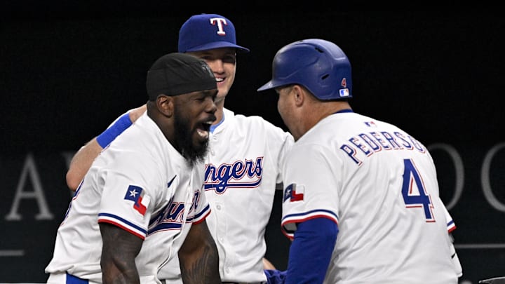 Aug 4, 2025; Arlington, Texas, USA; Texas Rangers pinch hitter Joc Pederson (4) celebrates with right fielder Adolis Garcia (53) and designated hitter Josh Jung (6) after Pederson hits a game tying home run against the New York Yankees during the ninth inning at Globe Life Field. 