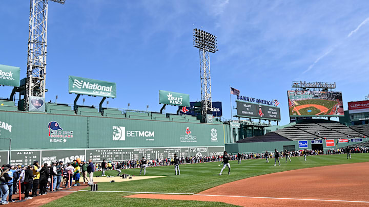 Apr 20, 2025; Boston, Massachusetts, USA; Fans line the field in front of the Green Monster as the Chicago White Sox warm up before a game at Fenway Park. Mandatory Credit: Eric Canha-Imagn Images