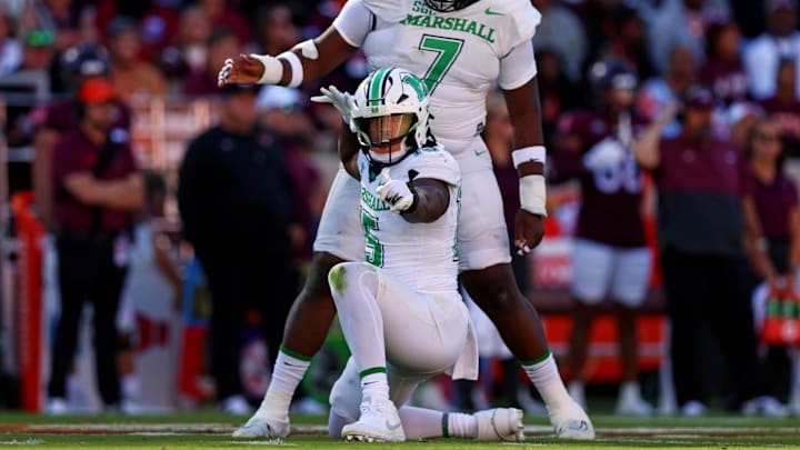 Sep 7, 2024; Blacksburg, Virginia, USA; Marshall Thundering Herd defensive lineman Mike Green (15) celebrates after sacking Virginia Tech Hokies quarterback Kyron Drones (1) during the first quarter at Lane Stadium. Mandatory Credit: Peter Casey-Imagn Images Sep 7, 2024; Blacksburg, Virginia, USA; Marshall Thundering Herd defensive lineman Mike Green (15) celebrates after sacking Virginia Tech Hokies quarterback Kyron Drones (1) during the first quarter at Lane Stadium. Mandatory Credit: Peter Casey-Imagn Images