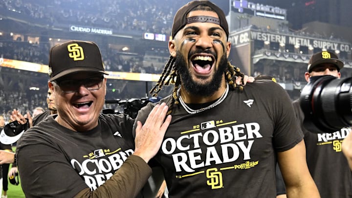 Oct 2, 2024; San Diego, California, USA; San Diego Padres manager Mike Shildt (8) and third baseman Manny Machado (13) celebrate after winning the Wildcard round for the 2024 MLB Playoffs against the Atlanta Braves at Petco Park. Mandatory Credit: Denis Poroy-Imagn Images