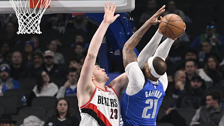 Jan 9, 2025; Dallas, Texas, USA; Dallas Mavericks center Daniel Gafford (21) shoots over Portland Trail Blazers center Donovan Clingan (23) during the first quarter at the American Airlines Center. Mandatory Credit: Jerome Miron-Imagn Images