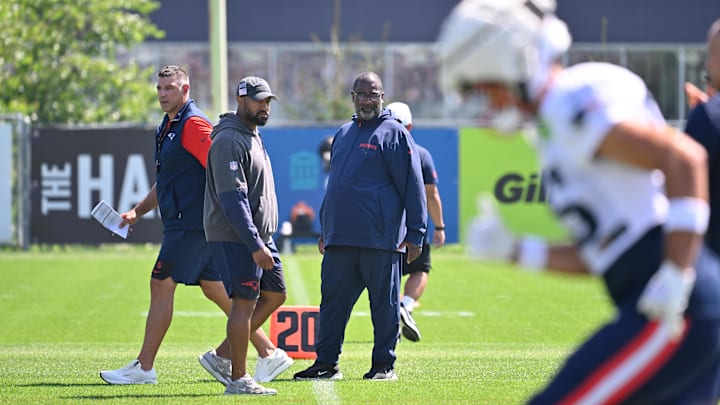 Jul 28, 2025; Foxborough, MA, USA; New England Patriots head coach Mike Vrabel (red sleeves and defensive coordinator Terrell Williams (blue pants) watch the team during training camp at Gillette Stadium. Mandatory Credit: Eric Canha-Imagn Images
