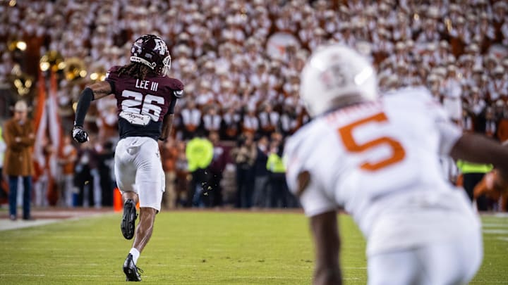 Nov 30, 2024; College Station, Texas, USA; Texas Longhorns wide receiver Ryan Wingo (5) watches as Texas A&M Aggies defensive back Will Lee III (26) runs the ball in to score a touchdown after an interception in the third quarter of the Lone Star Showdown at Kyle Field. Mandatory Credit: Sara Diggins/USA TODAY Network via Imagn Images