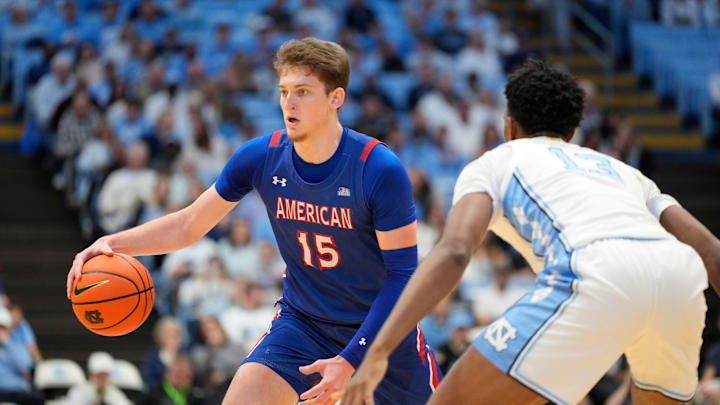 Nov 15, 2024; Chapel Hill, North Carolina, USA; American University Eagles forward Matt Rogers (15) with the ball as North Carolina Tar Heels forward Jalen Washington (13) defends in the first half at Dean E. Smith Center. Mandatory Credit: Bob Donnan-Imagn Images