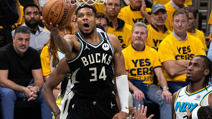 Apr 29, 2025; Indianapolis, Indiana, USA; Milwaukee Bucks forward Giannis Antetokounmpo (34) shoots the ball while  Indiana Pacers guard Andrew Nembhard (2) defends during game five of the first round for the 2024 NBA Playoffs at Gainbridge Fieldhouse. Mandatory Credit: Trevor Ruszkowski-Imagn Images