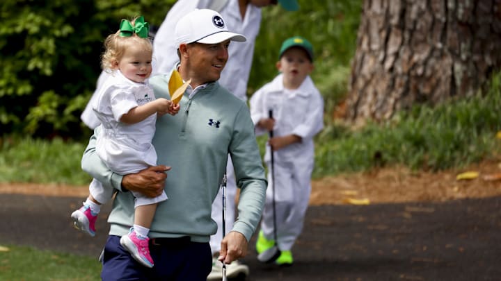 Jordan Spieth holds his daughter, Sophie, while being followed by his son, Sammy. 