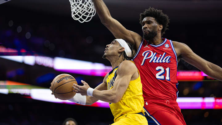 Dec 13, 2024; Philadelphia, Pennsylvania, USA; Indiana Pacers guard Andrew Nembhard (2) drives for a shot against Philadelphia 76ers center Joel Embiid (21) during the first quarter at Wells Fargo Center. Mandatory Credit: Bill Streicher-Imagn Images Dec 13, 2024; Philadelphia, Pennsylvania, USA; Indiana Pacers guard Andrew Nembhard (2) drives for a shot against Philadelphia 76ers center Joel Embiid (21) during the first quarter at Wells Fargo Center. Mandatory Credit: Bill Streicher-Imagn Images