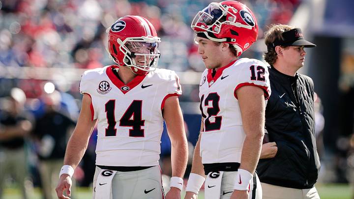 Nov 1, 2025; Jacksonville, Florida, USA; Georgia Bulldogs quarterback Gunner Stockton (14) talks with quarterback Ryan Puglisi (12) before a college football game against the Florida Gators at EverBank Stadium. Mandatory Credit: Travis Register-Imagn Images