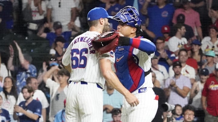 Aug 4, 2024; Chicago, Illinois, USA; Chicago Cubs pitcher Julian Merryweather (66) and catcher Miguel Amaya (9) celebrate their win against the St. Louis Cardinals at Wrigley Field. Mandatory Credit: David Banks-Imagn Images