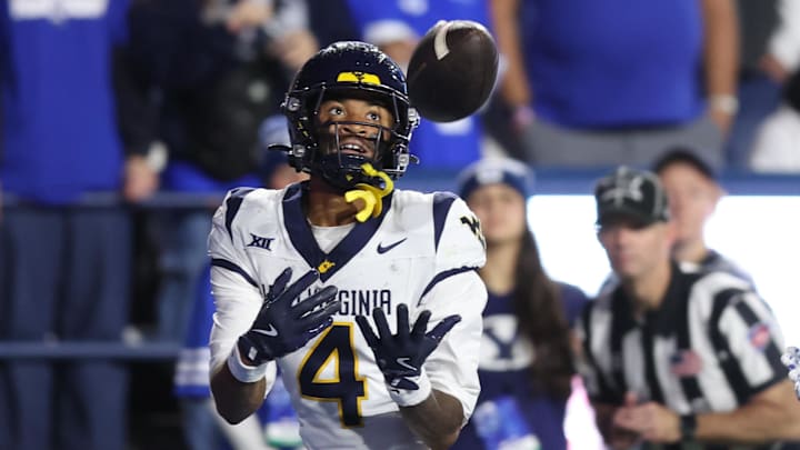 Oct 3, 2025; Provo, Utah, USA; West Virginia Mountaineers wide receiver Cam Vaughn (4) makes a catch for a touchdown against the Brigham Young Cougars during the fourth quarter at LaVell Edwards Stadium. Mandatory Credit: Rob Gray-Imagn Images