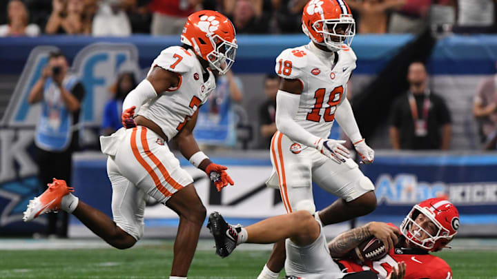 Aug 31, 2024; Atlanta, Georgia, USA; Clemson Tigers safety Khalil Barnes (7) and safety Kylon Griffin (18) run by Georgia Bulldogs quarterback Carson Beck (15) on the ground during the first quarter of the 2024 Aflac Kickoff Game at Mercedes-Benz Stadium. Mandatory Credit: Ken Ruinard-Imagn Images Aug 31, 2024; Atlanta, Georgia, USA; Clemson Tigers safety Khalil Barnes (7) and safety Kylon Griffin (18) run by Georgia Bulldogs quarterback Carson Beck (15) on the ground during the first quarter of the 2024 Aflac Kickoff Game at Mercedes-Benz Stadium. Mandatory Credit: Ken Ruinard-Imagn Images