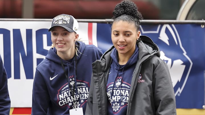 Former UConn star Paige Bueckers and current UConn star Azzi Fudd walk onto the stage during the Final Four Champions victory parade and rally outside of the XL Center in Hartford, CT.