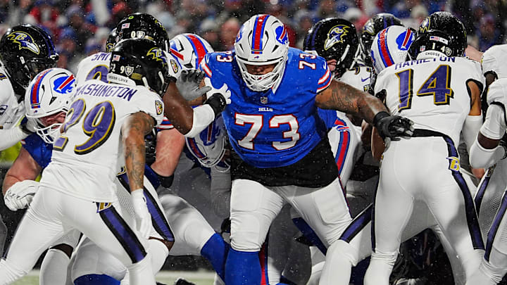 Buffalo Bills Dion Dawkins blocks for quarterback Josh Allen, behind him, who sneaks in for a touchdown