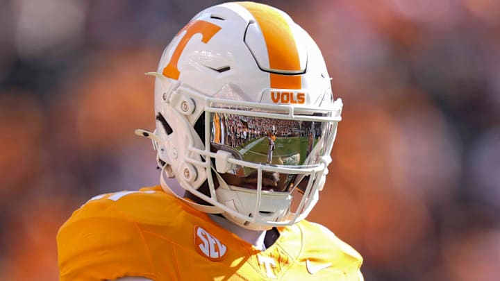 A Tennessee player warm-ups in the reflection of Tennessee defensive back Tre Poteat's (21) helmet before a college football game between Tennessee and Arkansas at Neyland Stadium in Knoxville, Tenn., on Oct. 11, 2025.