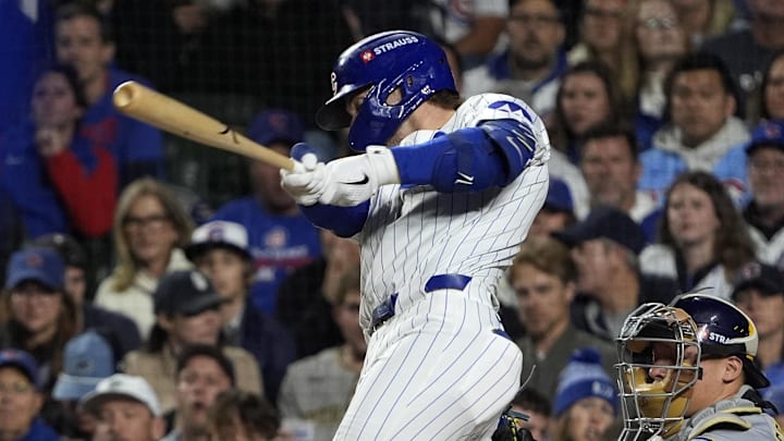Oct 9, 2025; Chicago, Illinois, USA; Chicago Cubs second baseman Nico Hoerner (2) hits a single against the Milwaukee Brewers during the first inning for game four of the NLDS round for the 2025 MLB playoffs at Wrigley Field. Mandatory Credit: David Banks-Imagn Images