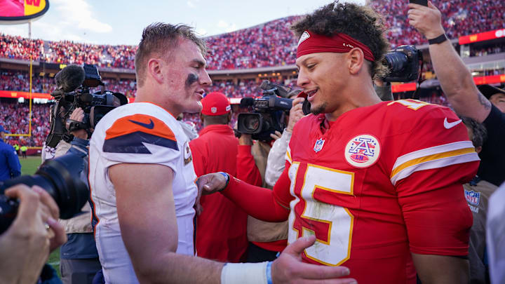 Nov 10, 2024; Kansas City, Missouri, USA; Denver Broncos quarterback Bo Nix (10) talks with Kansas City Chiefs quarterback Patrick Mahomes (15) after the game at GEHA Field at Arrowhead Stadium. 