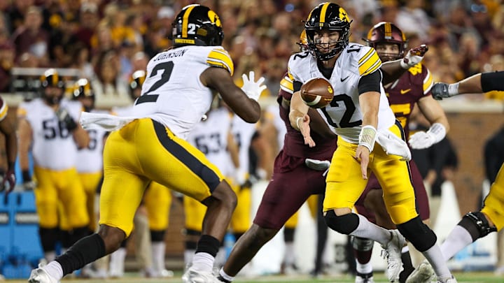 Sep 21, 2024; Minneapolis, Minnesota, USA; Minnesota Golden Gophers wide receiver Jalen Smith (12) flips the ball to running back Kaleb Johnson (2) during the second half against the Minnesota Golden Gophers at Huntington Bank Stadium. Mandatory Credit: Matt Krohn-Imagn Images