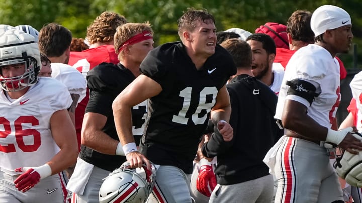 Aug 8, 2024; Columbus, Ohio, USA; Ohio State Buckeyes quarterback Will Howard (18) runs during football practice at the Woody Hayes Athletic Complex. Aug 8, 2024; Columbus, Ohio, USA; Ohio State Buckeyes quarterback Will Howard (18) runs during football practice at the Woody Hayes Athletic Complex.