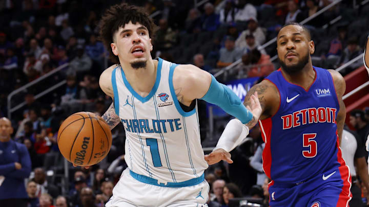 Jan 24, 2024; Detroit, Michigan, USA;  Charlotte Hornets guard LaMelo Ball (1) dribbles on Detroit Pistons guard Monte Morris (5) in the second half at Little Caesars Arena. Mandatory Credit: Rick Osentoski-Imagn Images