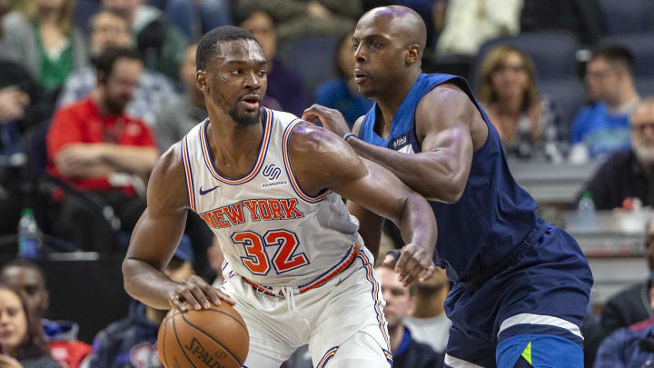 Mar 10, 2019; Minneapolis, MN, USA; New York Knicks forward Noah Vonleh (32) controls the ball defended by Minnesota Timberwolves forward Anthony Tolliver (43) in the second half at Target Center. Mandatory Credit: Jesse Johnson-USA TODAY Sports