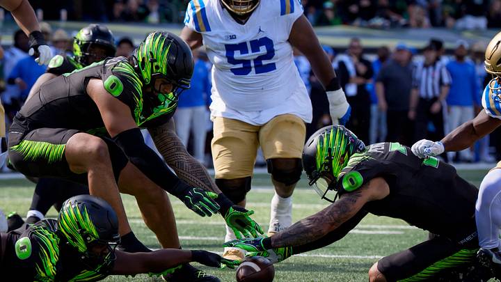 Oregon defensive back Koi Perich, right, dives on a fumbled ball as the Oregon Ducks host the UCLA Bruins on Oct. 10, 2026, at Autzen Stadium in Eugene, Oregon.