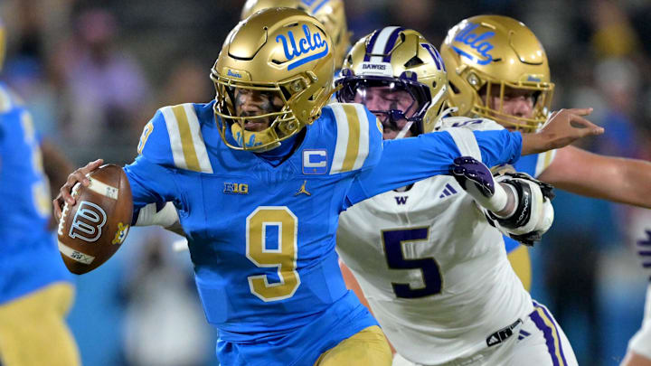 Nov 22, 2025; Pasadena, California, USA;  UCLA Bruins quarterback Nico Iamaleava (9) the grasp of Washington Huskies linebacker Zach Durfee (5) during the second half at the Rose Bowl. Mandatory Credit: Jayne Kamin-Oncea-Imagn Images